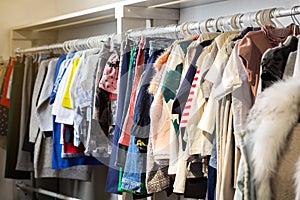 Clothes hang on a shelf in a designer store