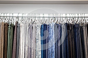 Clothes hang on a shelf in a designer store