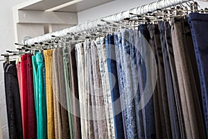 Clothes hang on a shelf in a designer store