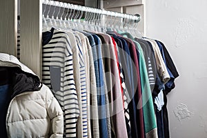 Clothes hang on a shelf in a designer store