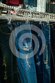 Clothes hang on a shelf at a night market in Thailand