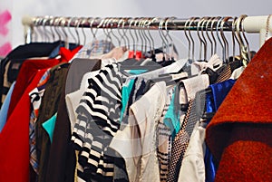 Clothes hang on a shelf on a yardsale sale photo