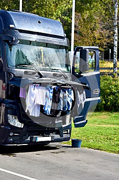 Clothes hang to dry under open bonnet