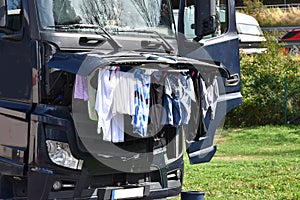 Clothes hang to dry under open bonnet