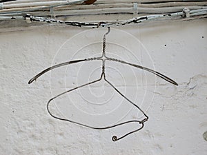 clothes hanger made of iron thread hanging on a electricity cable