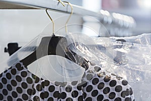 Clothes on a hanger in a modern designer boutique store