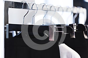 Clothes on a hanger in a modern designer boutique store