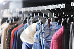 Clothes on a hanger in a modern designer boutique store