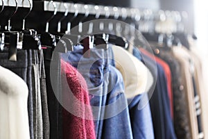 Clothes on a hanger in a modern designer boutique store