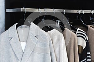 Clothes on a hanger in a modern designer boutique store