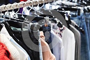 Clothes on a hanger in a modern designer boutique store