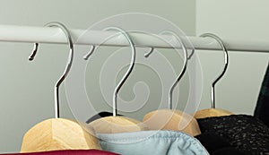 Clothes hangers on the bar in a clothing store. Retail store business illustration, hanger close-up