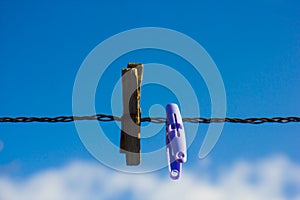 Clothes hangers on a line with blue background