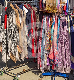 Clothes on hangers in a retail shop. Women clothing. Shop window with women clothing