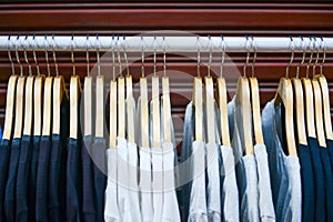 Clothes on hangers on a shelf in the store