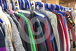 Clothes on hangers in a store. A lot of beautiful clothes. Concept: retail, second hand. Background