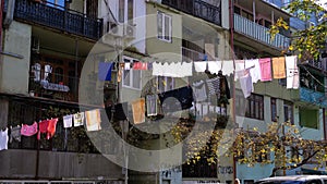 Clothes hanging and drying on a rope on a multi-story building in a poor district of the city