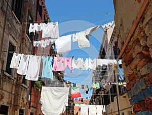 clothes hanging out drying in the sun in the narrow street of th