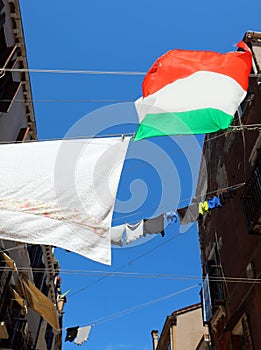 clothes hanging out drying in the sun in the narrow street of th