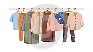 Clothes hanging on rack, hanger rail. Casual female wardrobe, modern garments hanging. Modern women apparel, wearing