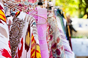 Clothes hanging on a rack in a street market