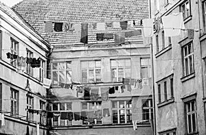 Clothes hanging to dry on a clothes-line. Laundry dryings on the rope. Washed clothes drying outside of an old house