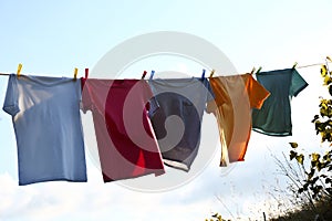 Clothes hanging on washing line against sky