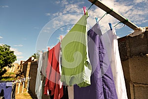 Clothes hanging in yard of house to dry