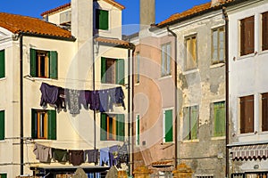 Clothes hung out to dry in the sun in the picturesque houses of Pellestrina island, Venetian lagoon, Italy