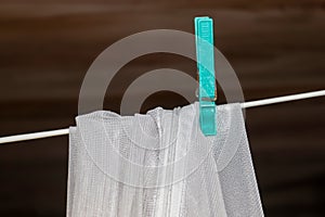 Clothes hung out to dry on a washing line and fastened by the clothes pegs