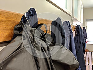 Clothes hung up on pegs in a changing room blue