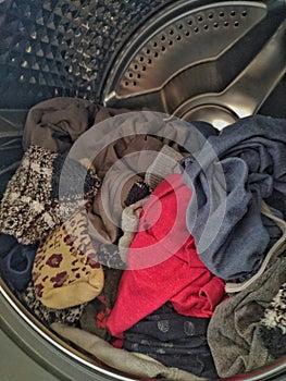 Clothes inside a washing machine after being dried up. Shot in Sao Paulo, Brazil. photo