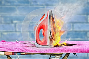 Clothes iron and ironing board in the fire