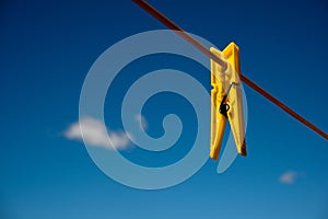 Clothes peg and blue sky background.