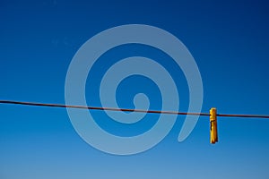 Clothes peg and blue sky background.