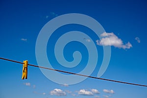 Clothes peg and blue sky background.