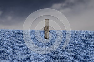 Clothes peg on a blue towel and washing