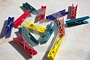 Clothes pegs of colored plastic under the sun