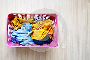 Clothes in pink plastic laundry basket. Laundry concept