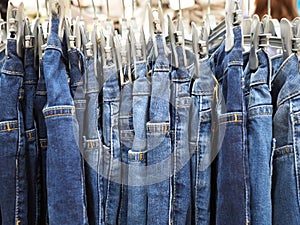 Clothes rack of blue jeans in department store, close up