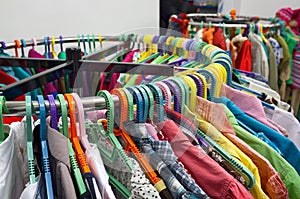 Clothes on racks in a store.