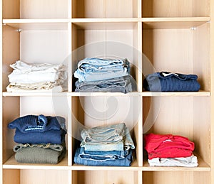 Clothes on regiments in a wardrobe