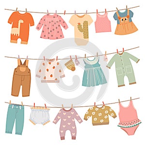 Clothes on ropes. Baby dress, infant cloth hang on rope. Cute children clothing after washing on clothesline, isolated