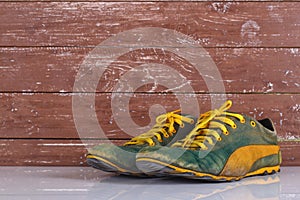 Clothes shoes and accessories - Old pair green sneakers wooden background reflection
