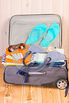 Clothes, shoes and tablets for travel are ready and lie in a sui