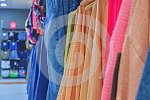 Clothes shop Costume dress. Fashion store. Style Concept. Colorful women`s dresses on hangers in a retail shop. Fashion and shopp