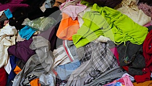 Clothes stacked together for donations by winter