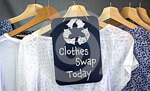 Clothes Swap and recycle clothes icon on chalk board with hanging shirts to swap, sustainable fashion and zero waste