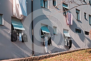 Clothes, towels and bed sheets hanging out of the window to dry Pesaro, Italy