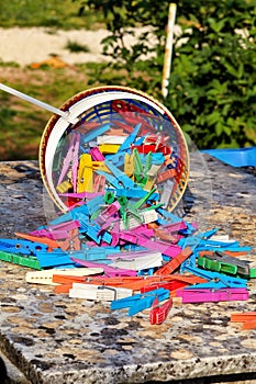 Clothespin in the basket stand on table in garden